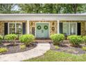 Charming brick home featuring a welcoming double door entry, well-manicured landscaping, and decorative wreaths at 120 Labans Ln, Lincolnton, NC 28092