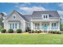 Inviting home featuring a classic porch with a cheerful, bright blue front door at 1327 Springlake Rd, York, SC 29745