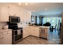 Bright kitchen features stainless appliances, stylish flooring, and ample counter space at 150 Wordsworth Way, Mooresville, NC 28115