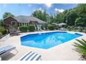 Sparkling pool surrounded by comfortable seating in a private backyard setting at 150 Wordsworth Way, Mooresville, NC 28115