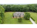 Expansive property showcasing a well-manicured lawn, mature trees, and beautiful home exterior at 1533 Ohara Plantation Ct, Dallas, NC 28034