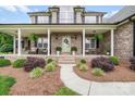 Inviting home entrance with a covered porch, brick facade, and landscaped walkway at 1533 Ohara Plantation Ct, Dallas, NC 28034