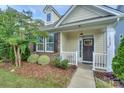 Lovely home showcasing a stone facade, well-maintained landscaping, and a welcoming front entrance at 16508 Landen Forest Ln, Davidson, NC 28036