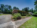 Spacious brick home with a wide driveway, mature trees, and a well-maintained landscaped yard at 1830 Huntington Pl, Rock Hill, SC 29732