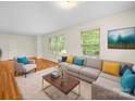 Bright living room with hardwood floors, large windows, and a comfortable seating area at 1830 Huntington Pl, Rock Hill, SC 29732