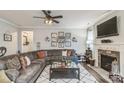 Comfortable living room featuring a fireplace, ceiling fan, and an area rug at 2112 Balting Glass Dr, Indian Trail, NC 28079