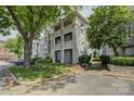 Spacious condo complex with outdoor parking, beautiful balconies, and manicured greenery at 226 Queens Rd # 68, Charlotte, NC 28204