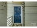 Inviting blue front door with secure entry and stylish welcome mat at 226 Queens Rd # 68, Charlotte, NC 28204