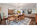 Bright dining room with hardwood floors, modern chandelier, and seamless open flow to the living spaces at 2507 Connemara Dr, Matthews, NC 28105