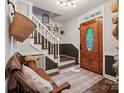 Welcoming entryway with wooden door, bench seating, decor, and staircase to the upper level at 2507 Connemara Dr, Matthews, NC 28105