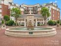 Serene fountain in common area, with landscaped greenery and brick pavers, offering a peaceful outdoor space for residents at 300 W 5Th St # 433, Charlotte, NC 28202