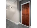 Condo 433 with a solid door, neutral walls, and updated hallway lighting and carpet, offering a quiet entry at 300 W 5Th St # 433, Charlotte, NC 28202