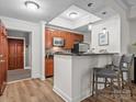 Inviting kitchen featuring wood cabinets, breakfast bar with seating, and stainless steel appliances for modern living at 300 W 5Th St # 433, Charlotte, NC 28202