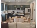 Modern kitchen with green cabinets, stainless steel appliances, and dining table, perfect for cooking and entertaining at 320 Lawrence Gray Rd, Charlotte, NC 28262