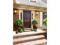 Inviting front door adorned with potted plants and warm lighting, creating a welcoming entrance at 3214 Tilley Morris Rd, Matthews, NC 28105