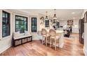Sunlit kitchen with island seating, modern pendant lighting, and hardwood floors for a bright feel at 3214 Tilley Morris Rd, Matthews, NC 28105