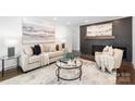 Cozy living room featuring a stylish brick fireplace and neutral decor at 4017 Sulkirk Rd, Charlotte, NC 28210