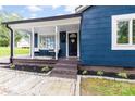 Inviting front porch with seating area and landscaped front yard at 403 W 2Nd St, Cherryville, NC 28021