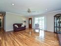 Bright living room with hardwood floors, complemented by a decorative ceiling fan, and a view of the entrance at 407 S Buckoak St, Stanley, NC 28164