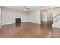 Spacious living room with a cozy fireplace, hardwood floors, and plenty of natural light at 463 Hunton Forest Nw Dr, Concord, NC 28027