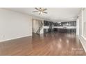 Open-concept living room flows into kitchen, featuring hardwood floors and ample natural light at 463 Hunton Forest Nw Dr, Concord, NC 28027