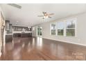Bright living room connects to kitchen, boasting hardwood floors and sliding door to backyard at 463 Hunton Forest Nw Dr, Concord, NC 28027