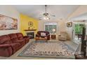 Inviting living room featuring a cozy fireplace, plush seating, and a decorative ceiling fan at 4810 Shea Ct, Monroe, NC 28110