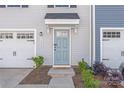 Home's entrance featuring a light blue front door and a cozy welcome mat at 5023 Daybell St, Charlotte, NC 28214