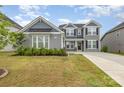 Attractive two-story home featuring manicured lawn and a welcoming facade at 5043 Baileys Run Dr, Rock Hill, SC 29732