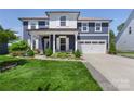 Inviting two-story home boasting a covered porch, pristine lawn, and attached two-car garage at 5050 Havencrest Dr, Fort Mill, SC 29715