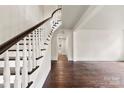 Elegant foyer showcasing a beautiful curved staircase and hardwood floors at 522 Alexander St, Statesville, NC 28677