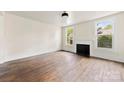 Bright living room featuring a fireplace and large windows, showcasing the home's original features at 522 Alexander St, Statesville, NC 28677