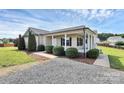 Attractive single-story home with a covered porch and manicured shrubs lining the walkway at 5333 Lake Glenn Dr, Stanfield, NC 28163