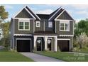 Beautiful two-story home featuring elegant siding, black garage doors, a well manicured lawn and welcoming front porch at 5615 Lantana Ave # A, Charlotte, NC 28205