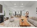 Open-concept living space with a fireplace, modern decor, and seamless transition to the dining area at 5615 Lantana Ave # A, Charlotte, NC 28205