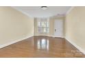 Spacious living room featuring hardwood floors, natural light, and neutral paint for versatile decor at 6011 Nw Village Nw Dr, Concord, NC 28027