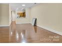 Open-concept living space with hardwood flooring and ample natural light in a well-maintained home at 6011 Nw Village Nw Dr, Concord, NC 28027