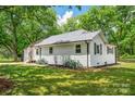 A wide shot of the side of a well-maintained house, showcasing a lush green lawn at 615 & 625 Irish Potato Rd, Concord, NC 28025