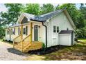 Side view of home displaying new entryway, vinyl siding, and fresh landscaping at 615 & 625 Irish Potato Rd, Concord, NC 28025