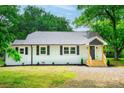 Charming home featuring new landscaping, a wooden entryway, and black window shutters at 615 & 625 Irish Potato Rd, Concord, NC 28025