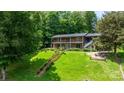 A spacious two-story home with an expansive backyard, landscaped stairs, and a fire pit area, ideal for outdoor gatherings at 6256 Monford Dr, Conover, NC 28613