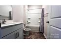 The bathroom features a tub and shower combo and a grey vanity with great floors at 640 Yellow Birch Dr, Locust, NC 28097