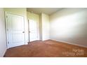 This is a bedroom that has two doors and carpet flooring and great lighting at 640 Yellow Birch Dr, Locust, NC 28097