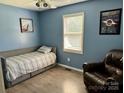This bedroom features a comfortable single bed and a relaxed sitting area at 667 Blossom Hill Rd, Lincolnton, NC 28092