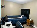 This bedroom features a bed with a blue cover and matching furniture at 667 Blossom Hill Rd, Lincolnton, NC 28092