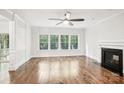 Open living room with hardwood floors, fireplace and large windows bring in natural light at 8521 Aspen Ct, Charlotte, NC 28227