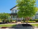 Charming two-story home featuring landscaped front yard with mature trees at 909 Herrons Ferry Rd, Rock Hill, SC 29730