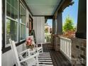 Cozy front porch featuring rocking chairs, black and white rug, and view of neighborhood at 909 Herrons Ferry Rd, Rock Hill, SC 29730