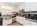 Updated kitchen featuring stainless steel appliances, granite countertops and white cabinetry at 1104 Colony Ct, Gastonia, NC 28056