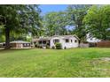 Well-maintained home with a spacious lawn and mature trees providing ample shade at 1109 S Highland Ave, Landis, NC 28088